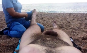 lucky-guy-has-a-sexy-lady-massaging-his-feet-on-the-beach